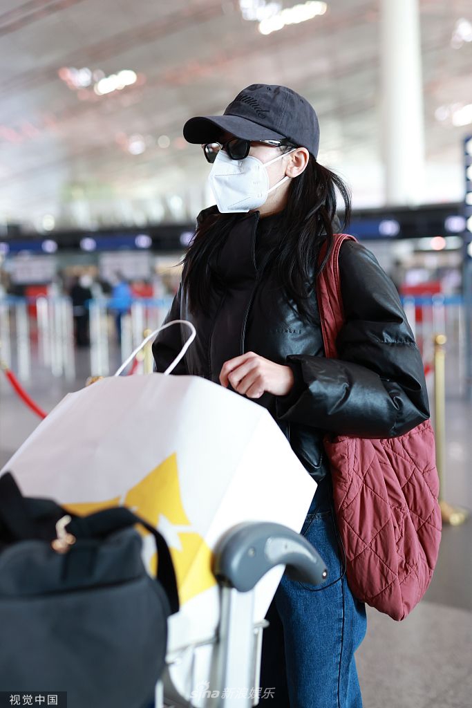 组图:迪丽热巴着黑色羽绒服现身机场 亲自推行李箱