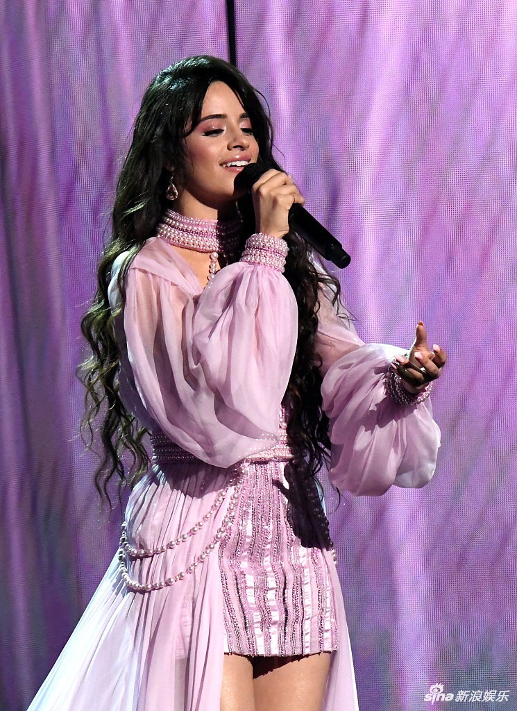 组图:卡妹一袭粉色长裙登台献唱秀美腿 卷发披肩温柔动人