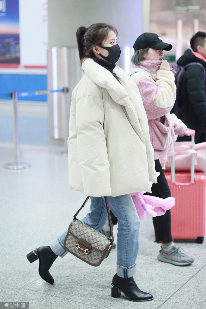 组图:白鹿穿羽绒服搭机清新甜美 获赠史迪仔玩偶笑眼弯弯