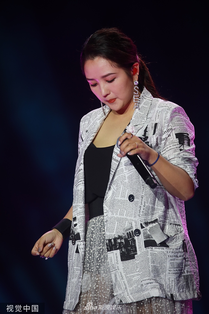 组图:何洁宣布减肥后首登台献唱 西装配纱裙大方秀腿超自信