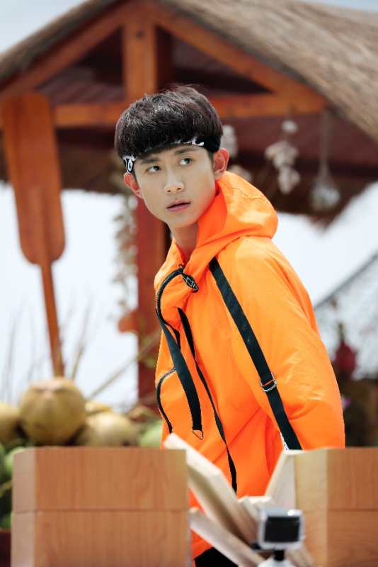 张一山身穿橘色外套回眸