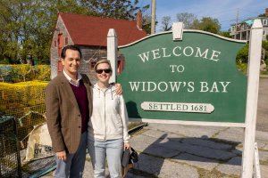 「Welcome to Widow’s Bay」と書かれた看板の前に立つ3人。