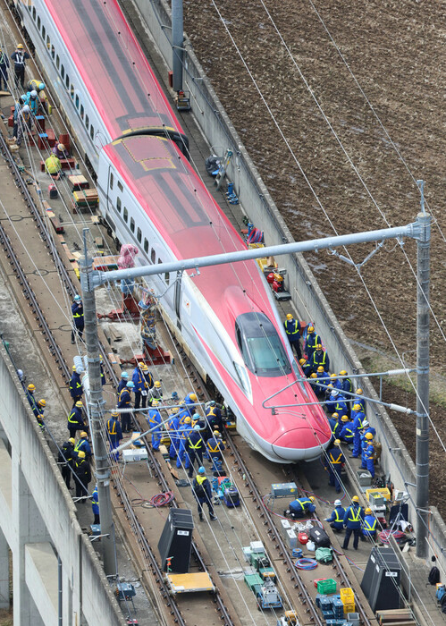 对脱轨的东北新干线进行修复作业的工作人员们，20日上午，宫城县白石市