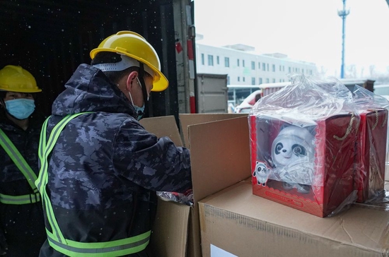 2月13日，工人在检查从货车上卸下的“冰墩墩”毛绒玩具。当日，新一批2000只“冰墩墩”毛绒玩具抵达位于北京市顺义区的金马工业园仓库，迅速投放市场。新华社记者 陈钟昊 摄