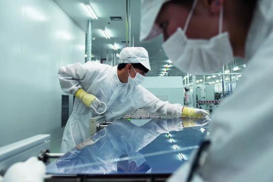 汉能的生产车间里，工人正在生产硅基薄膜太阳能电池。图/IC