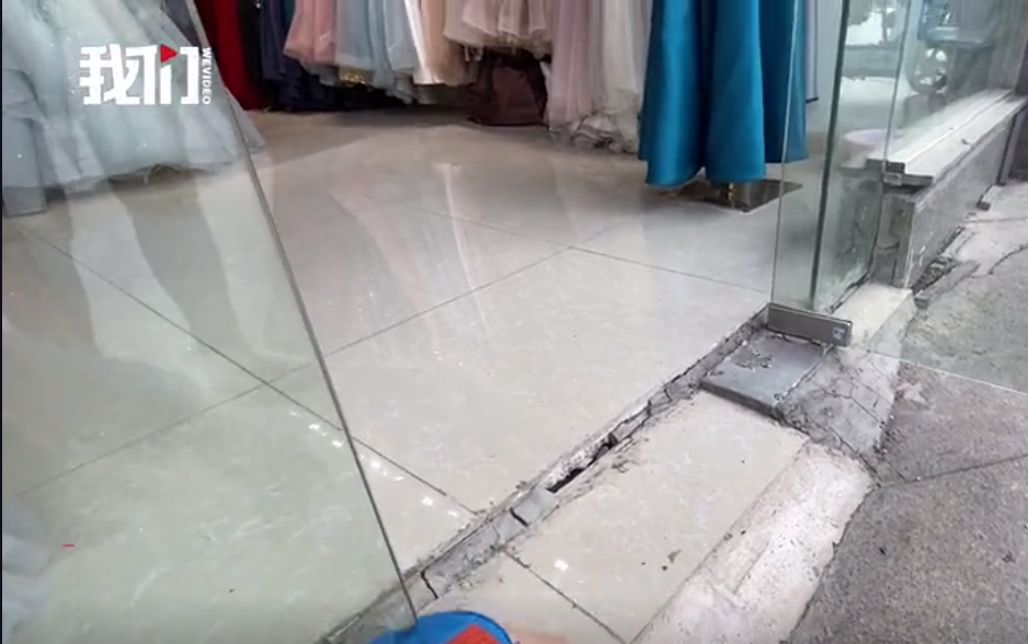 一家商户玻璃门随地面出现下沉情况。