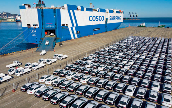 　2021年12月7日，出口商品车在山东烟台港登上运输船。
