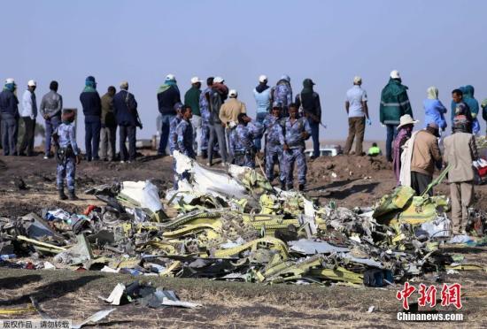  当地时间3月11日，在埃塞俄比亚首都亚的斯亚贝巴附近，救援人员在坠机现场清理飞机残骸。