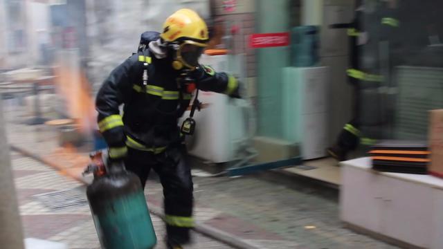 小吃店发生火灾 消防员徒手拎出5只燃烧液化罐
