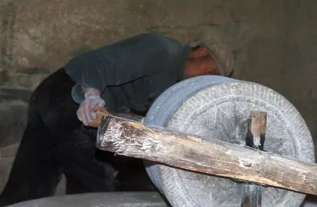 日本人拍摄的1976年中国:那时候农村用石磨碾米