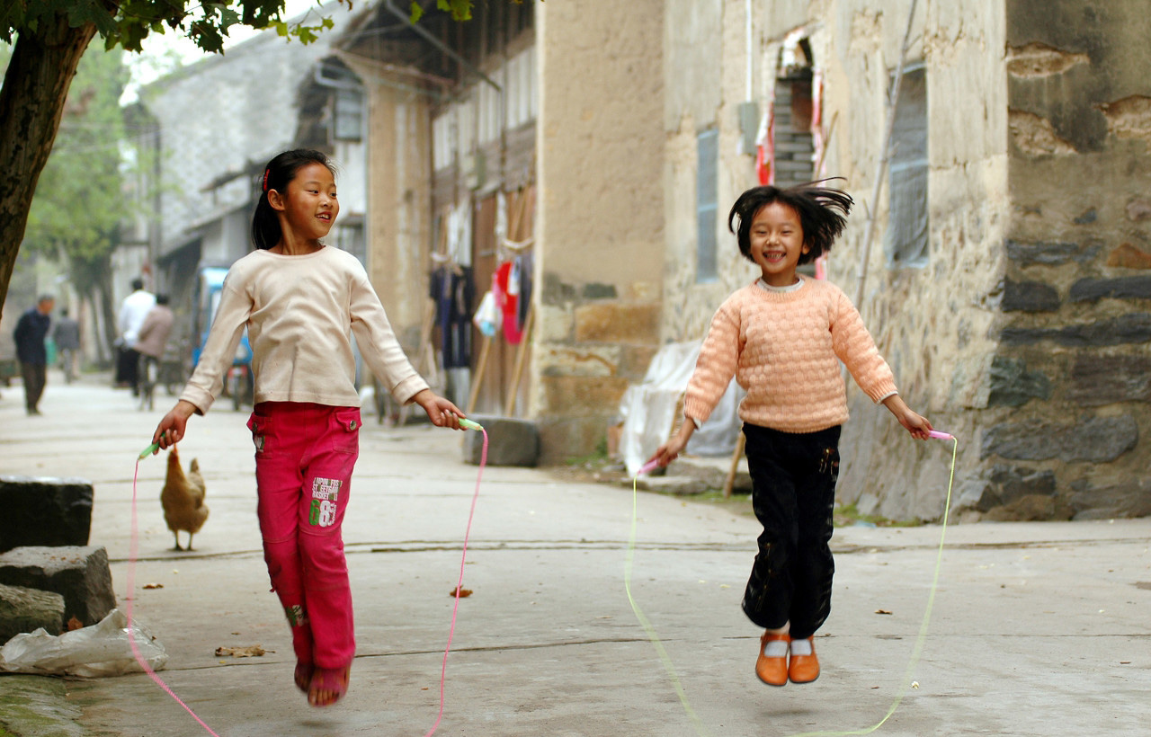 城市的孩子肯定没玩过2007年7月,安徽蒙城,农村的孩子手拉手围着树做