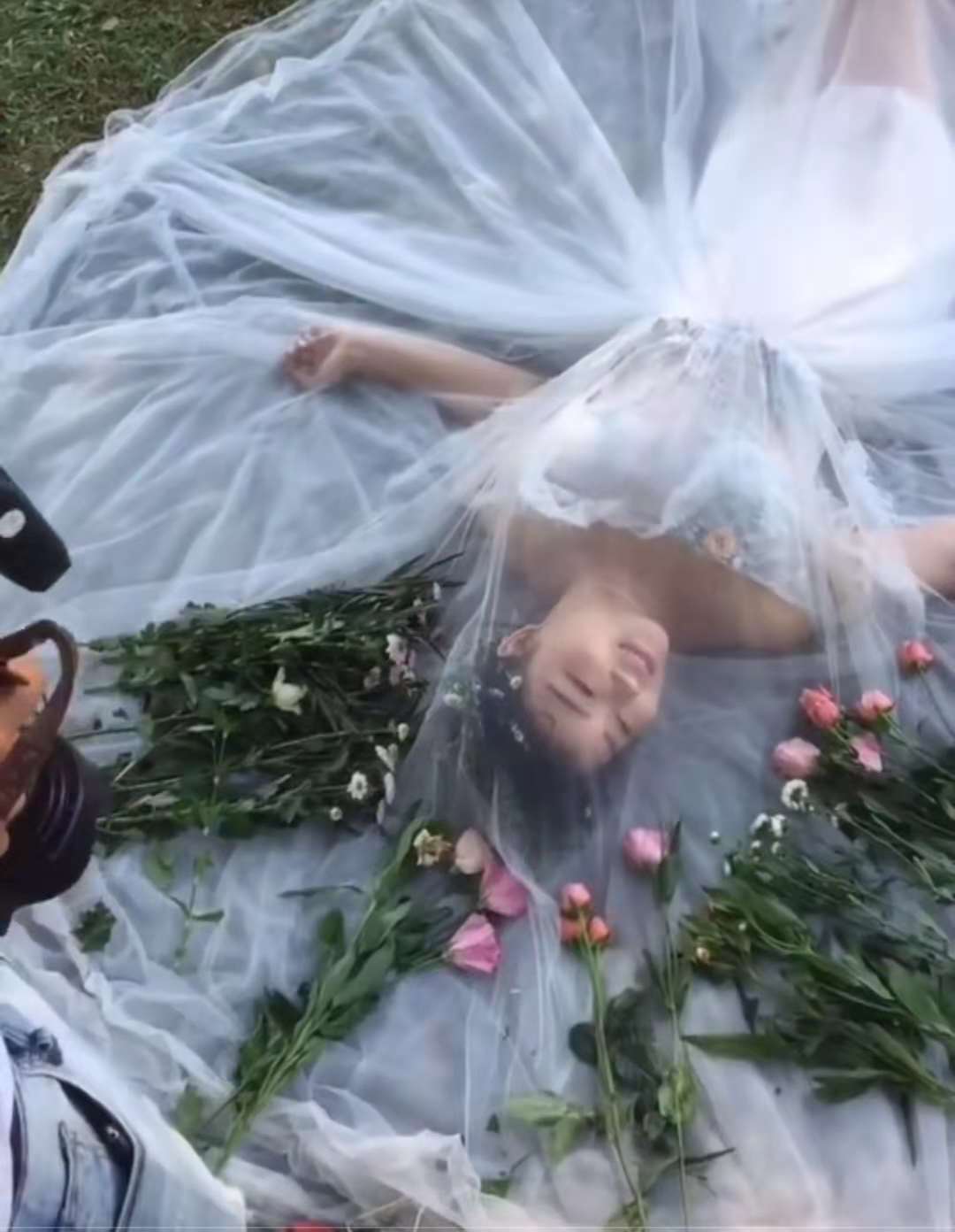 新娘躺地上拍婚纱照,身边摆满花束,网友:这是在举行告别仪式?
