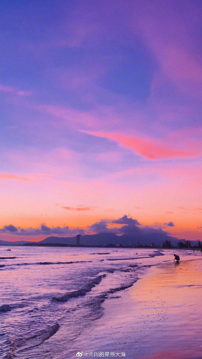 粉紫色的天空总会引人驻足,更何况是在海边遇到这绮丽的景象