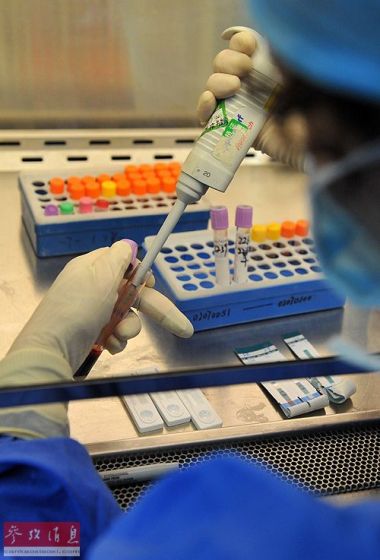 资料图片：疾病预防控制中心的医生在进行HIV阳性血样的检测工作。新华社记者 蔺以光 摄