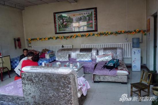 张家客厅。沙发旁边是张超凡生前睡的床。