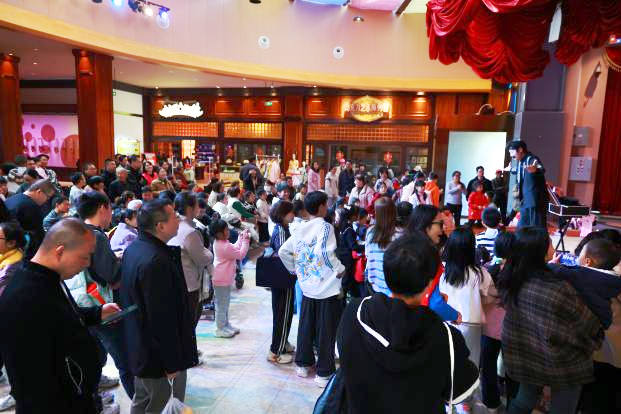 图为游客在奥园巧克力王国观赏魔术表演