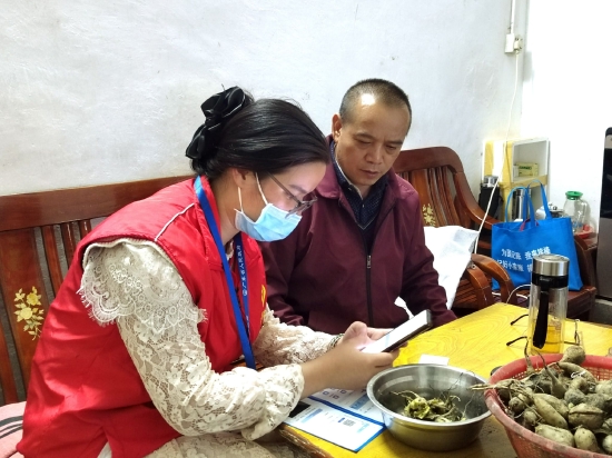 图为苏思慧到星光村入户开展“粤居码”志愿服务宣传活动,并现场演示使用方法