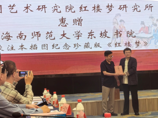 红楼梦研究所副所长石中琪（右）向海南师范大学东坡书院院长甘生统赠送最新校注本插图纪念珍藏版《红楼梦》。