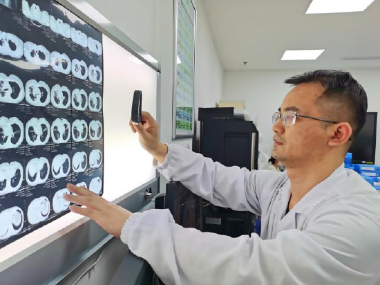 杨澄清正在研究患者的CT影像
