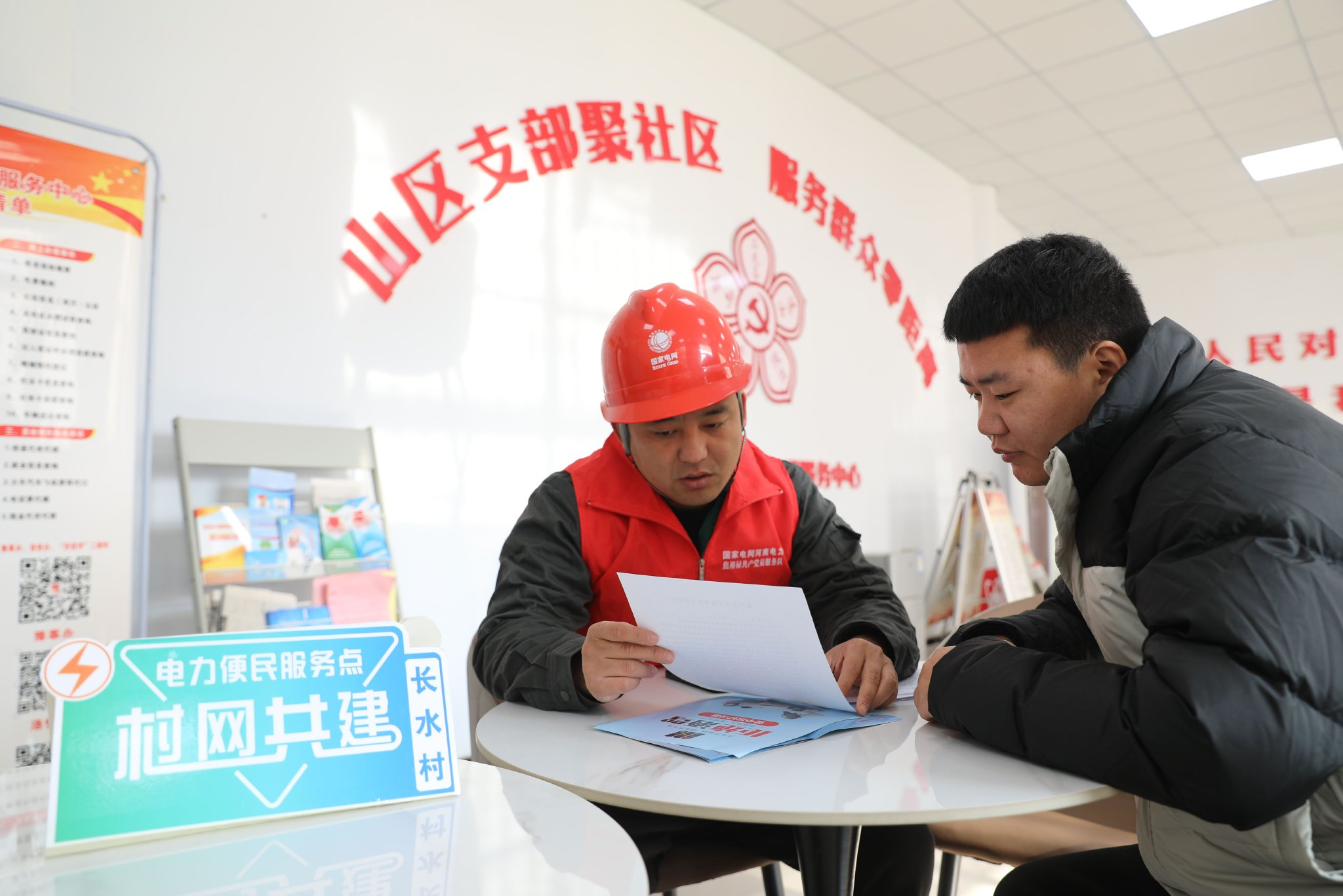 国网河南洛阳供电公司供电所员工在“村网共建”电力便民服务点提供办电服务。李志斌 摄