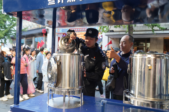 民警往便民茶水桶中装热水（拍摄：许萍）