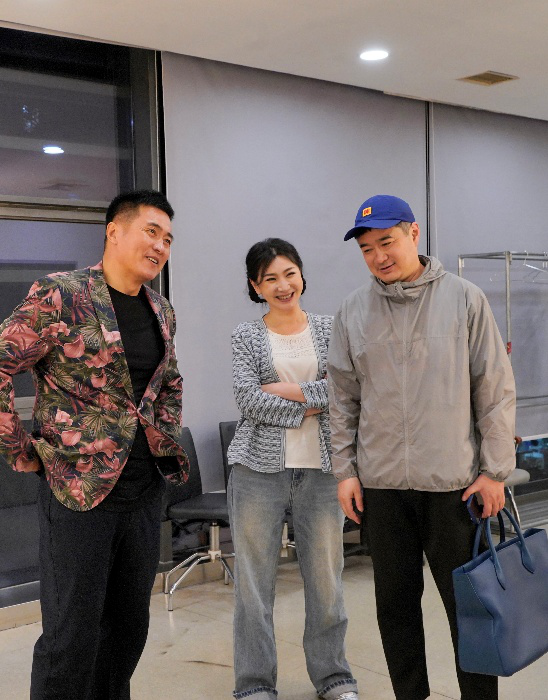 导演袁俊平（右）与演员那志东（左）、孙岚在后台交流