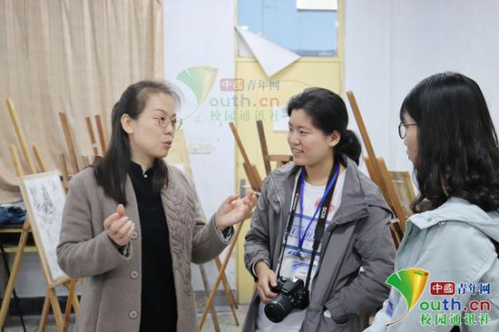 图为周娜(左)在与学生交流。
