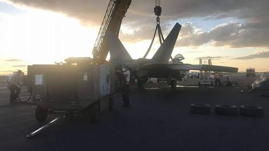 这是4月事故的F-22战机被吊走的现场图片。
