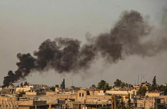 10月9日，在叙利亚东北部哈塞克省拉斯艾因，建筑物遭到炮击后冒出浓烟。新华社/法新