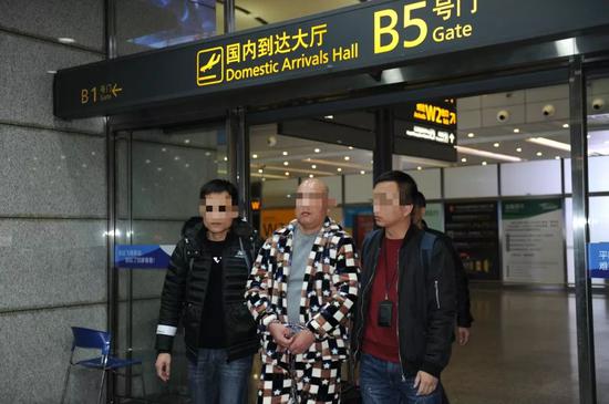 广州公交警方押解嫌疑人朱某（中）回穗。王正 摄