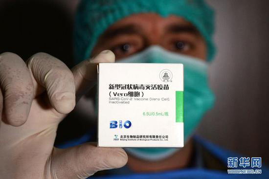 2021年2月3日，在巴基斯坦白沙瓦，一名医务人员展示中国捐赠的新冠疫苗。新华社发（奥马尔·卡尤姆摄）