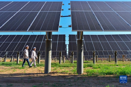 工作人员在内蒙古自治区鄂尔多斯市伊金霍洛旗天骄绿能50万千瓦采煤沉陷区生态治理光伏发电示范项目区里巡查（2021年7月8日摄）。 新华社发（王正 摄）