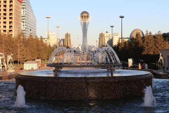 哈萨克斯坦首都努尔苏丹的喷泉和远处的巴伊杰列克观景塔。新华社记者 鲁金博 摄