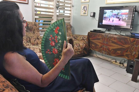 9月22日，在古巴首都哈瓦那，古巴电影制片人伊莉安娜·普波观看西班牙语中国纪录片《我的乡村故事》。新华社发（华金·埃尔南德斯摄）