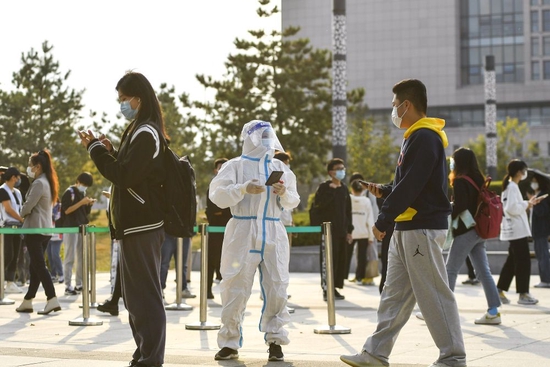 10月2日，在吉林省长春市一处便民核酸检测点，工作人员为前来进行核酸检测的市民扫码登记。新华社记者 许畅 摄