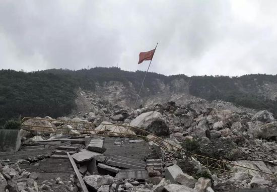 2019-06-18,在四川北川羌族自治县地震灾区,茅坝校区一片废墟,一面五星红旗在飘扬。