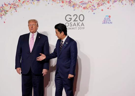 尴尬瞬间:梅姨与普京握手无表情 媒体盘点G20峰会尴尬瞬间 安倍与特朗普合影。/视觉中国