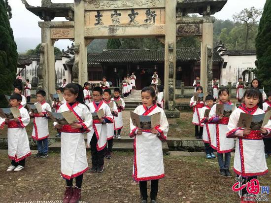 鹅湖小学学子在鹅湖书院石牌坊前诵读经典