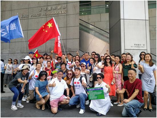 8日中午，数十名香港市民自发前往湾仔香港警察总部，高举五星红旗和撑警标语，声援警方。图片来源：大公文汇全媒体