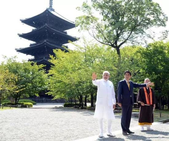 2014年8月31日，在日本京都东寺，日本首相安倍晋三（左二）与印度总理莫迪（左一）散步。新华社发