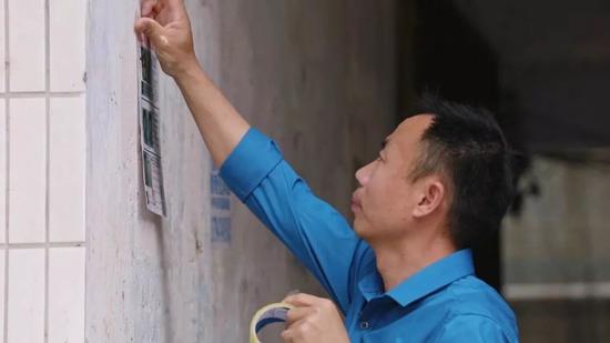  申军良在贴寻人启事。受访者供图