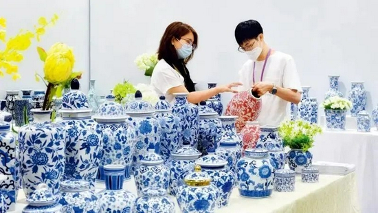 2021年10月15日,一名国内采购商(左)在第130届广交会瓷器展台洽谈业务 刘大伟摄/本刊
