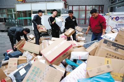 11月12日，朝阳区八里庄路，快递员分拣大量纸箱包装的快件。新京报记者 侯少卿 摄