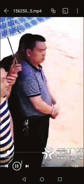 群眾為副鎮長打傘(截屏)。