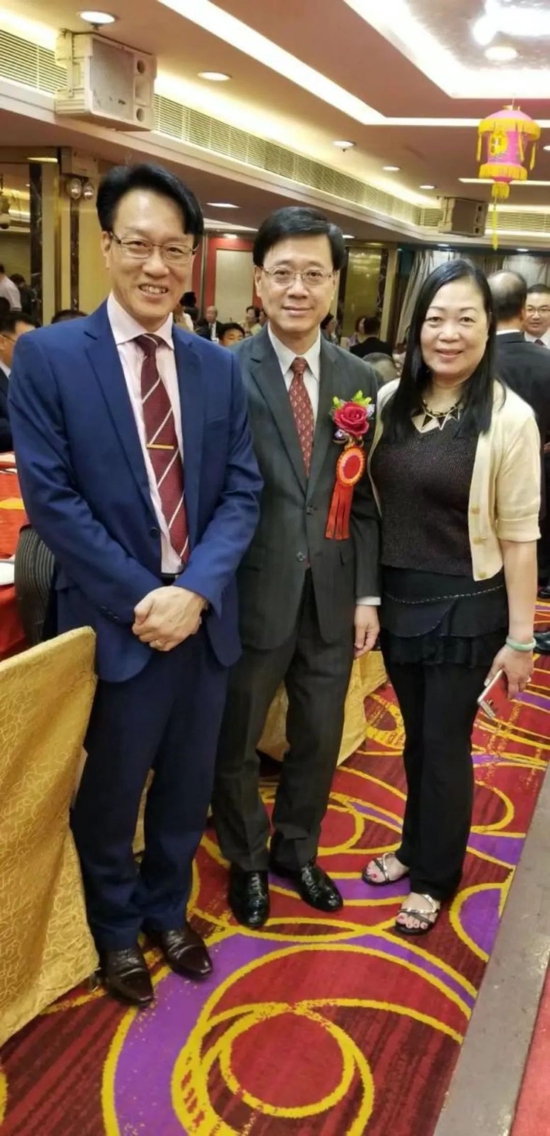 ·2017年，李家超（中）与校长黄锦耀（左）、校友何女士（右）在香港五邑工商总会96周年晚宴上的合影。（受访者供图）