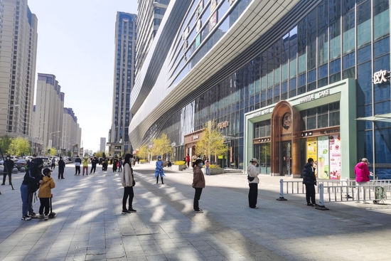 4月28日，在长春市一连锁超市外，市民有序排队等待进入。新华社发