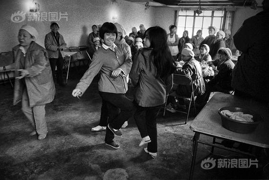 1995年春节，上海寅丰毛纺厂车间里，因买不到返乡火车票而在上海过年的外地打工妹。她们都是一线纺织女工，春节无法与家人团圆。摄影|于文国