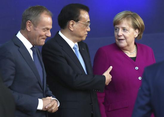 左起：欧盟理事会主席图斯克、国务院总理李克强、德国总理默克尔  图自美联社