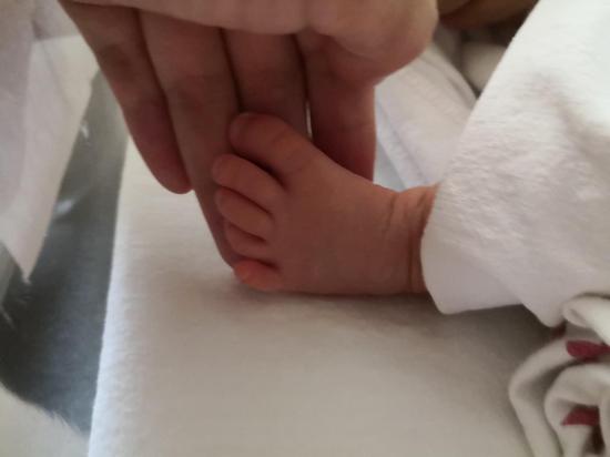 洛杉矶时间2月23日,小滚珠摸着女儿的脚丫。受访者供图