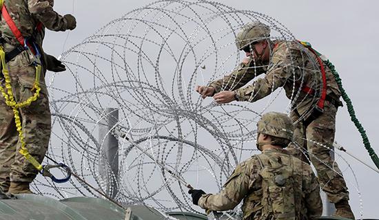 　　当地时间11月2日，中美洲移民大军压境美国，美国士兵在美墨边境安装铁丝网严防移民入境。  东方IC 图